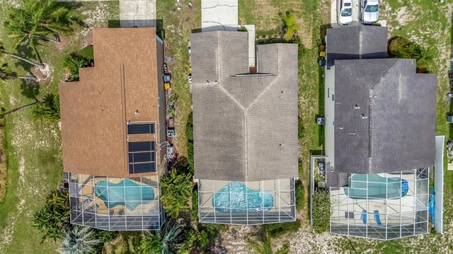 aerial view of a house with plants and large trees