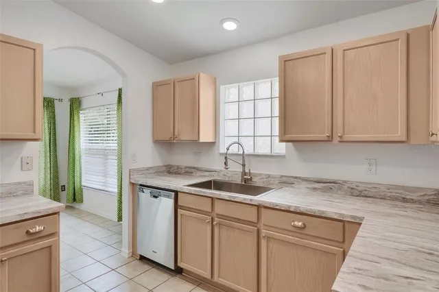a kitchen with stainless steel appliances granite countertop a sink and a stove