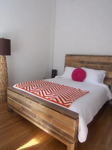 a bedroom with a bed and a night stand