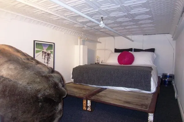 a bed room with a bed chair and a desk