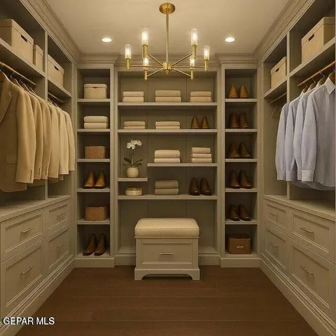 a view of walk in closet with clothes and shoes