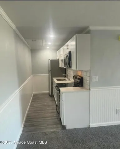 a kitchen with stainless steel appliances a refrigerator and a stove