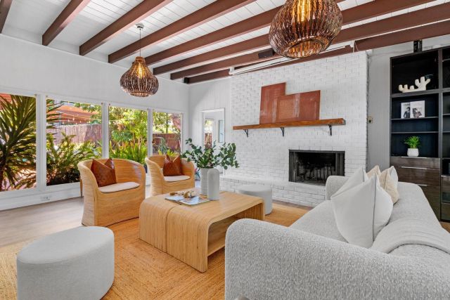 a living room with furniture and a potted plant