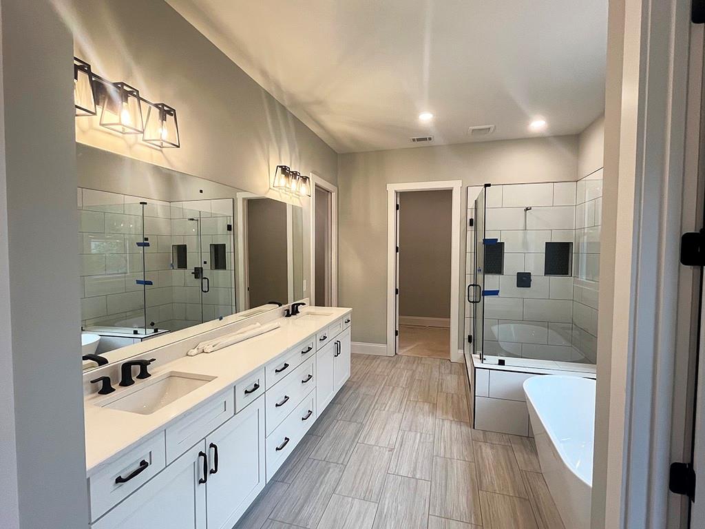 189 Pope Drive Canton, GA 30114 - Photo 14 of 20 a bathroom with a double vanity sink mirror and shower