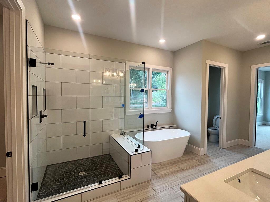 189 Pope Drive Canton, GA 30114 - Photo 16 of 20 a bathroom with a tub a sink and a shower