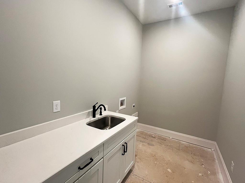 189 Pope Drive Canton, GA 30114 - Photo 17 of 20 a kitchen with a sink and cabinets