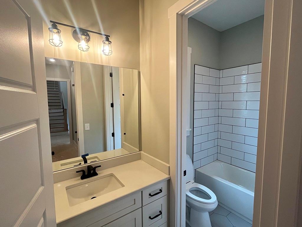 189 Pope Drive Canton, GA 30114 - Photo 18 of 20 a bathroom with a bathtub shower sink mirror vanity and toilet