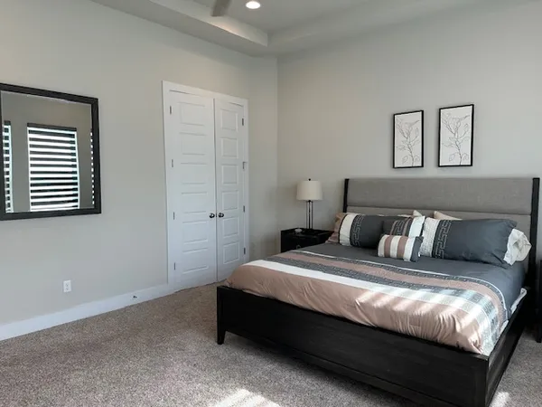 a bedroom with a bed and a night stand