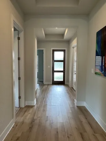 wooden floor in an empty room and a window