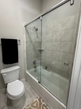 a bathroom with a toilet and a shower
