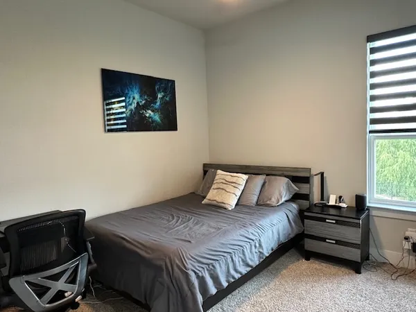 a bedroom with a bed and a window