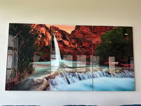 a view of swimming pool with a yard and palm trees