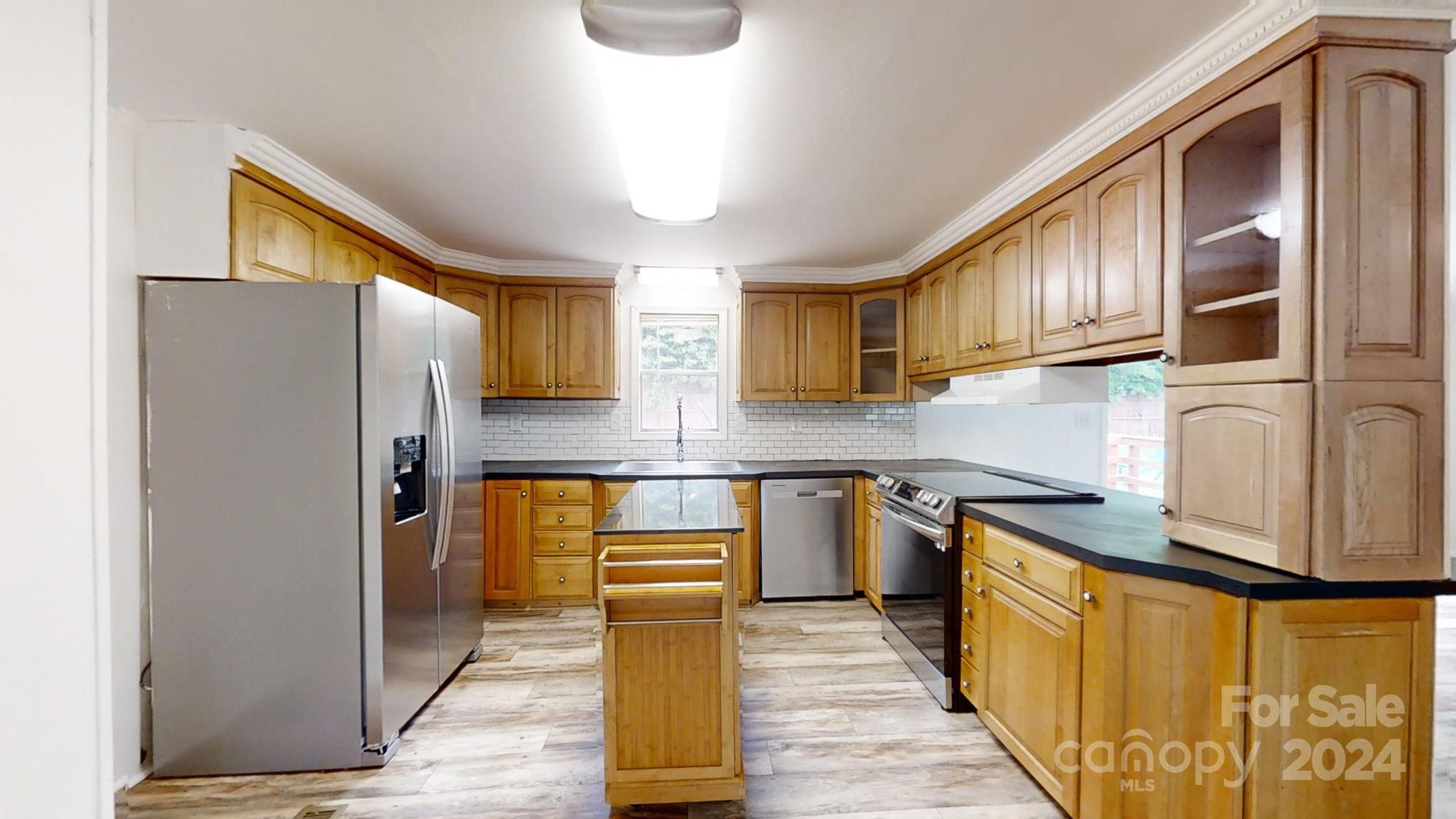 637 Hill Road Lincolnton, NC 28092 - Photo 14 of 26 a kitchen with stainless steel appliances granite countertop a refrigerator a stove and a sink