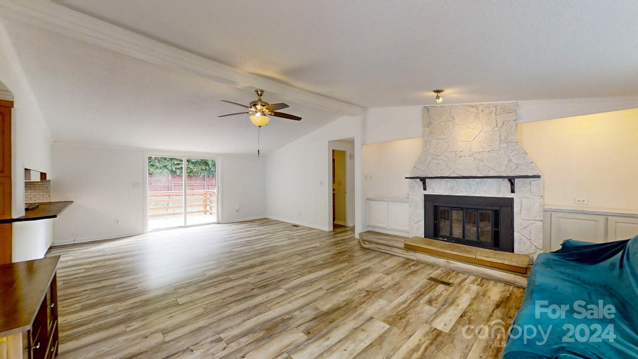 637 Hill Road Lincolnton, NC 28092 - Photo 7 of 26 a view of empty room with wooden floor and fireplace
