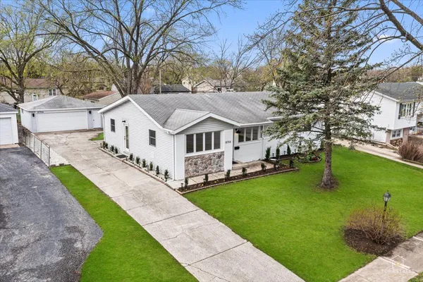 a front view of house with yard and green space