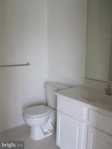 a white toilet sitting next to a sink