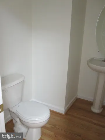 a white toilet sitting next to a shower