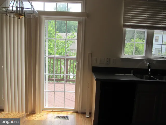 a kitchen with a sink a window and an umbrella