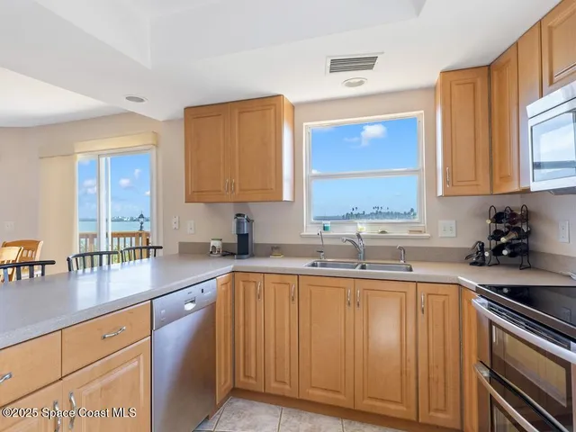 a kitchen with a sink cabinets and window