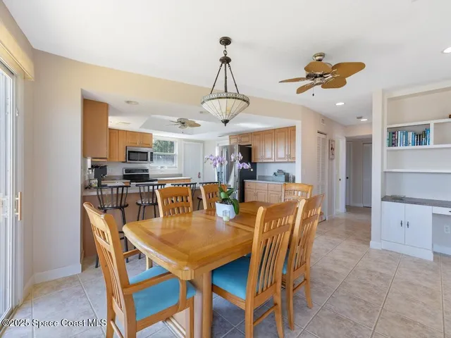 a dining room with furniture a chandelier and wooden floor