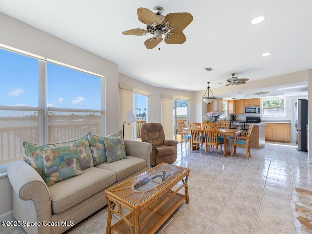 8820 44th Avenue Sebastian, FL 32958 - Photo 16 of 48 a living room with furniture kitchen view and a large window