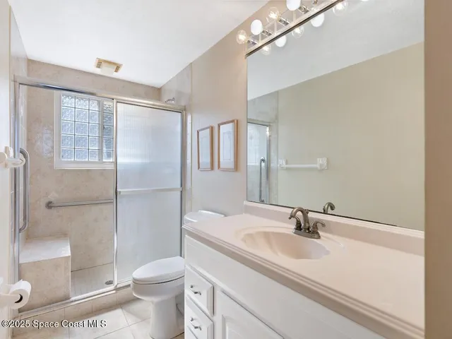 a bathroom with a sink toilet a mirror and shower