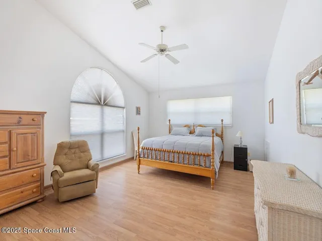 a bedroom with a bed and a couch