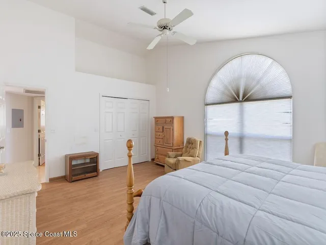 a bedroom with a bed and ceiling fan