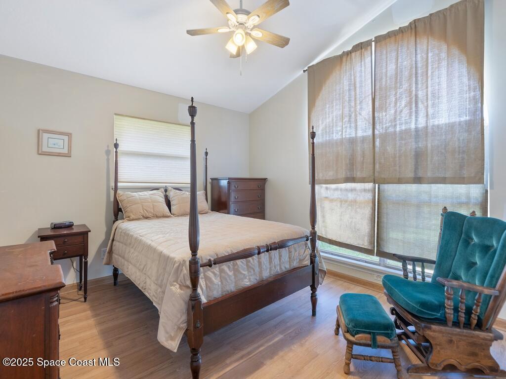 8820 44th Avenue Sebastian, FL 32958 - Photo 21 of 48 a bedroom with a bed and large window