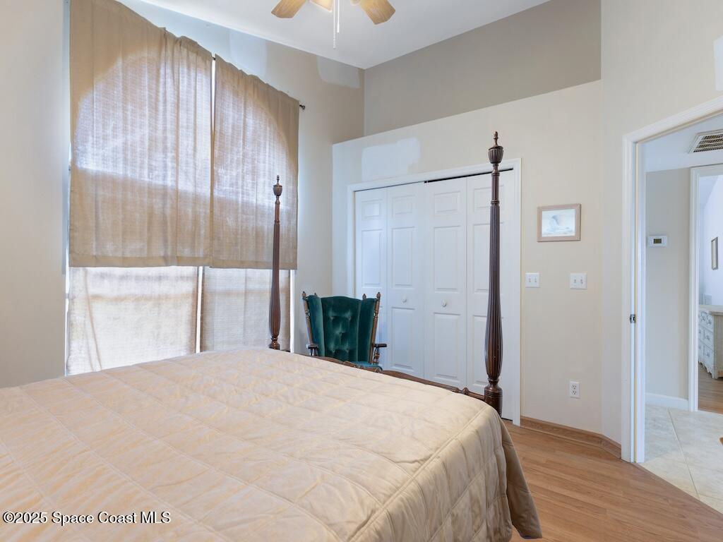 8820 44th Avenue Sebastian, FL 32958 - Photo 22 of 48 a bedroom with a large bed and a chandelier