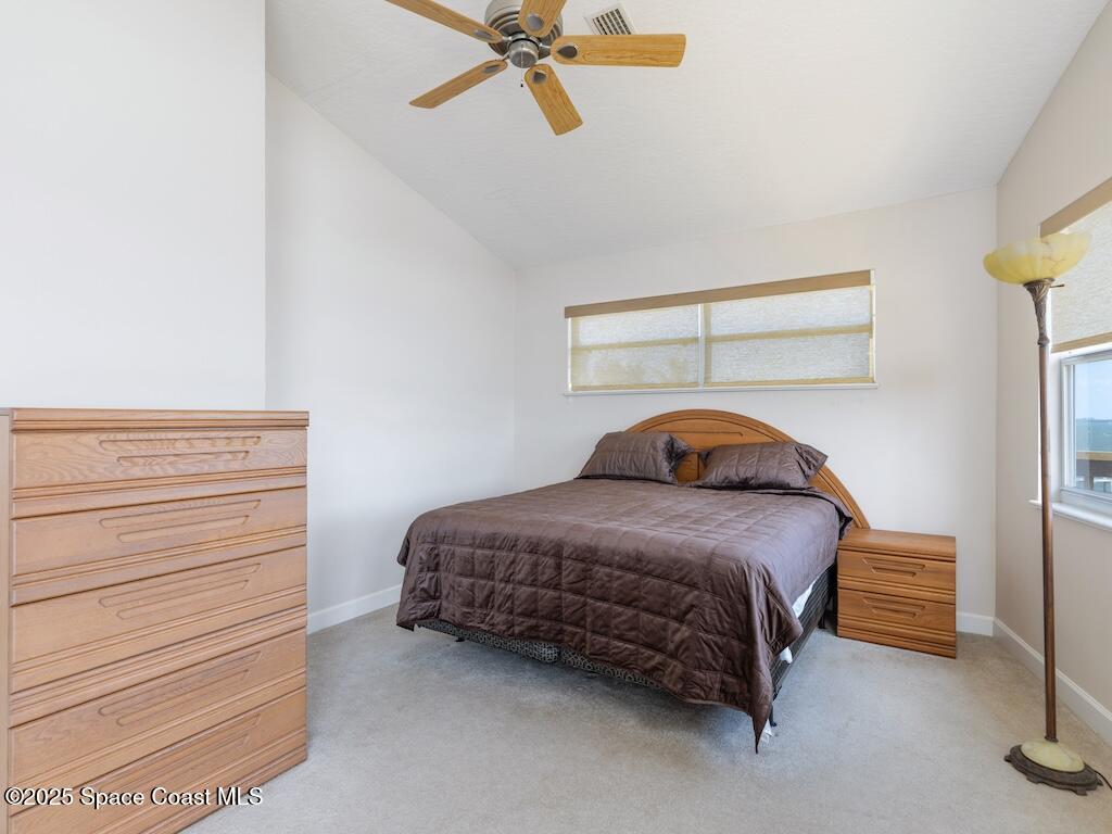 8820 44th Avenue Sebastian, FL 32958 - Photo 28 of 48 a bedroom with a bed and a chandelier