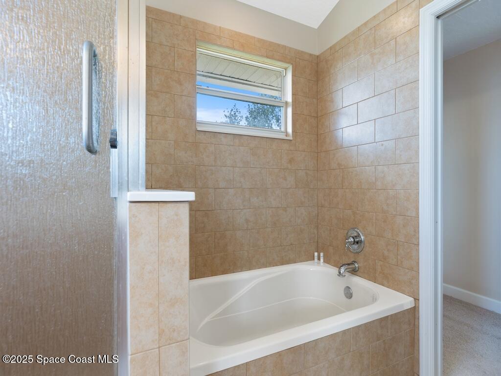 8820 44th Avenue Sebastian, FL 32958 - Photo 34 of 48 a white bath tub sitting next to a white sink