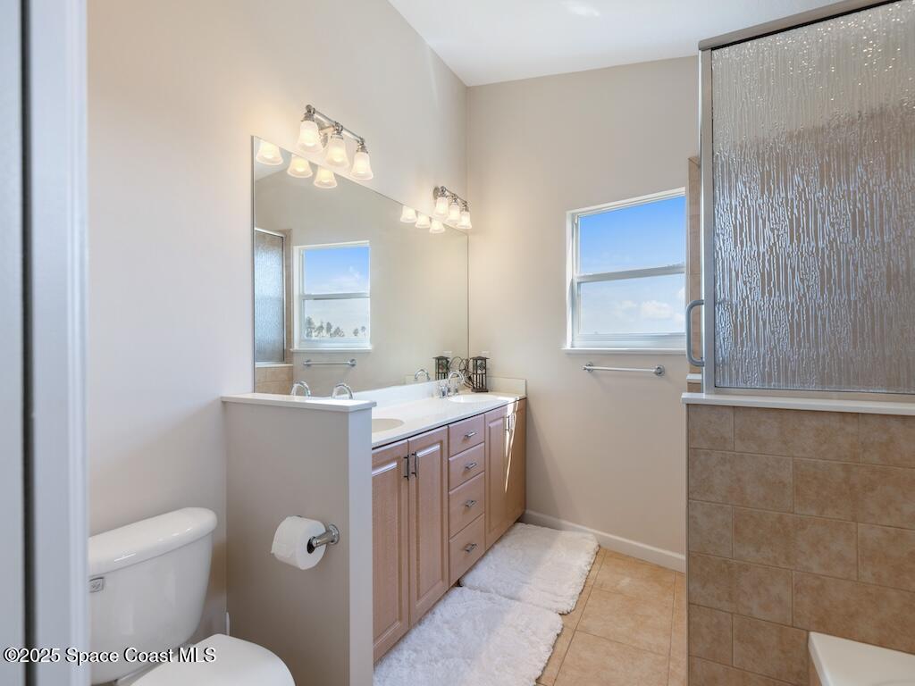 8820 44th Avenue Sebastian, FL 32958 - Photo 35 of 48 a view of bathroom with a toilet sink and mirror