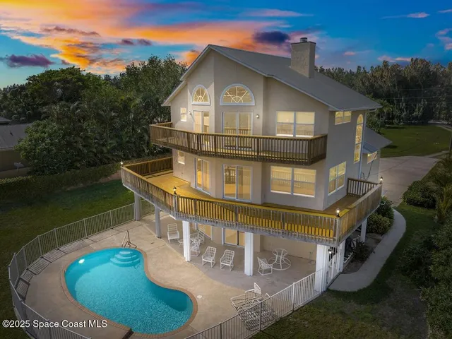 a view of a house with roof deck and garden