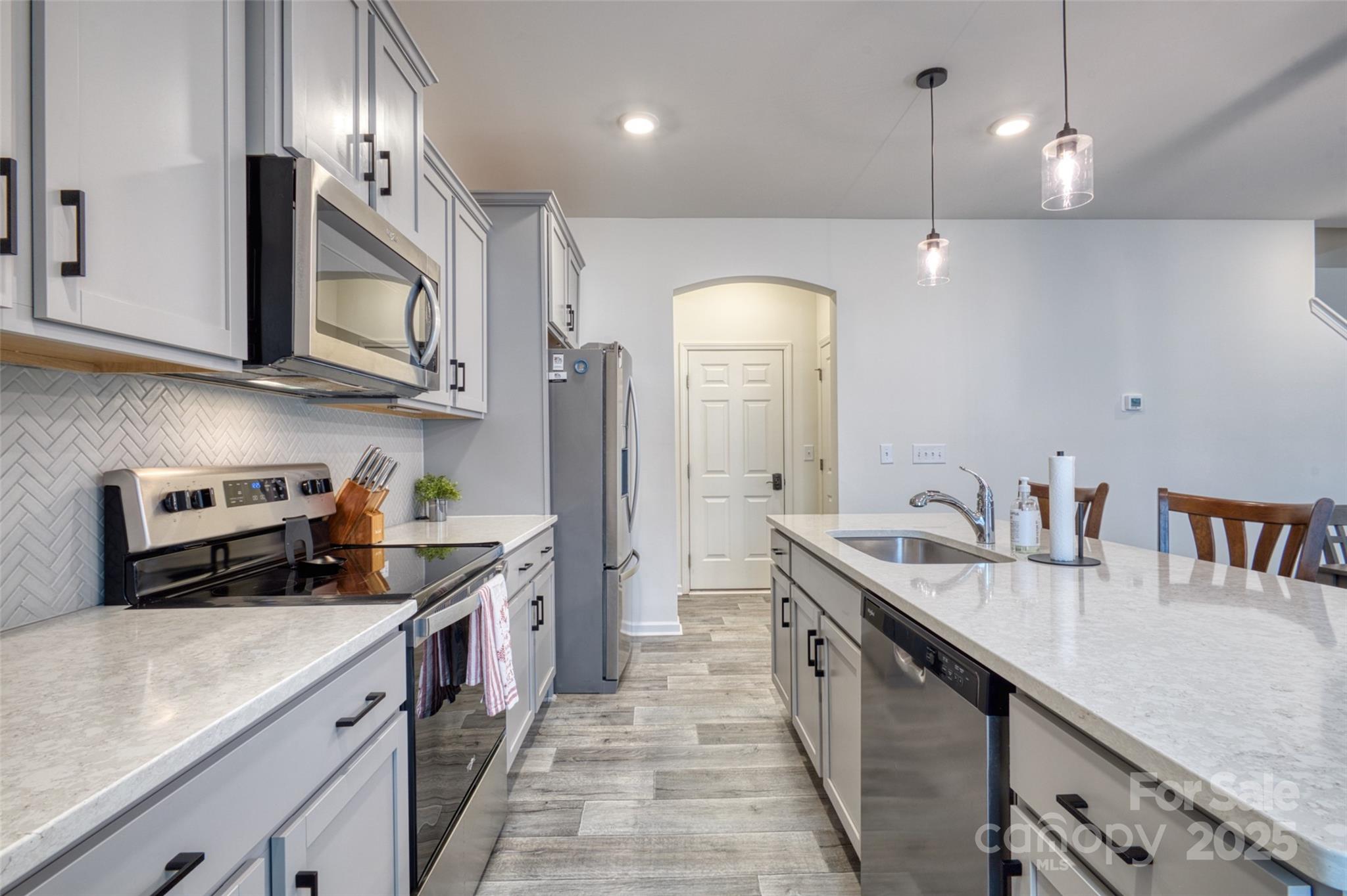620 Candela Court York, SC 29745 - Photo 15 of 46 a kitchen with stainless steel appliances granite countertop a sink a stove and a refrigerator