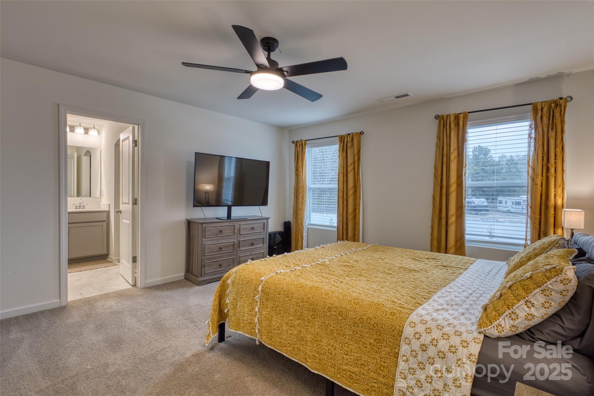 620 Candela Court York, SC 29745 - Photo 30 of 46 a spacious bedroom with a bed and a flat screen tv