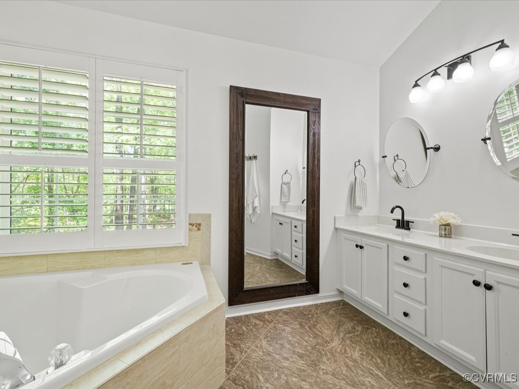 15418 Foxvale Way Midlothian, VA 23112 - Photo 22 of 50 a spacious bathroom with a tub sink and mirror