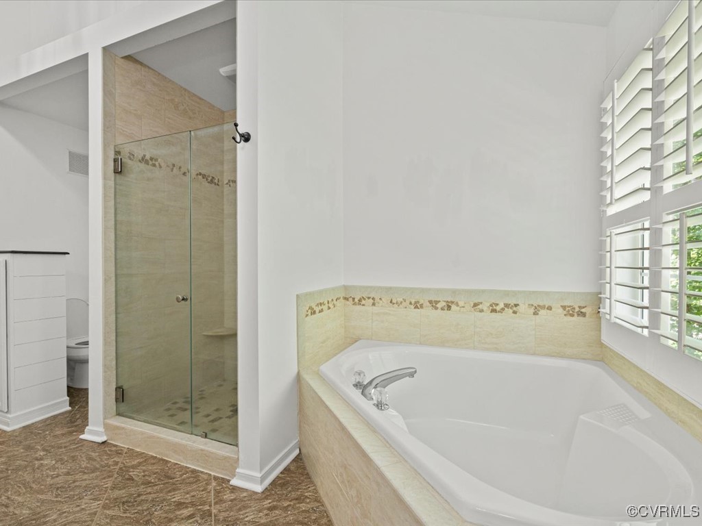 15418 Foxvale Way Midlothian, VA 23112 - Photo 23 of 50 a bathroom with a tub and shower