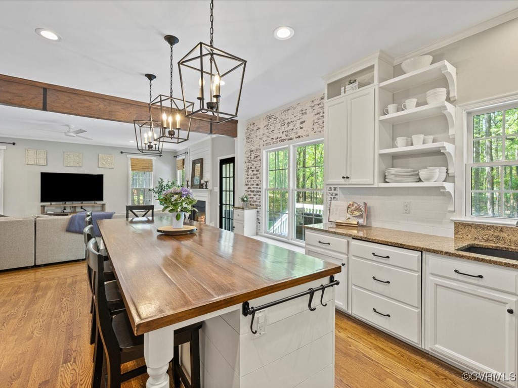 15418 Foxvale Way Midlothian, VA 23112 - Photo 6 of 50 a kitchen with a table chairs and flat screen tv