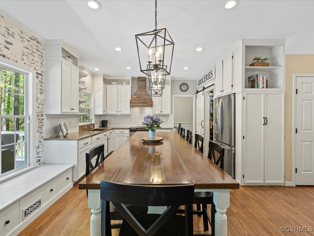 15418 Foxvale Way Midlothian, VA 23112 - Photo 7 of 50 a kitchen with stainless steel appliances a table chairs stove and cabinets