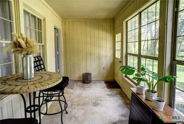 a living room filled with furniture and a potted plant
