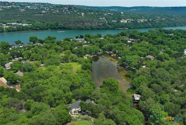 an aerial view of a houses with outdoor space and trees