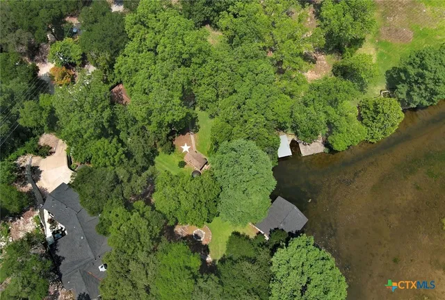 an aerial view of a house with a yard