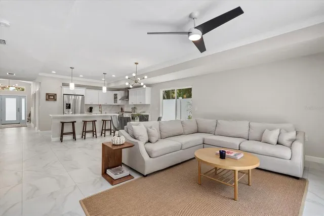 a living room with furniture and kitchen view