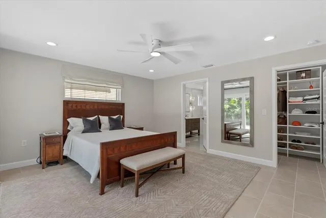 a bed room with a bed and a chair