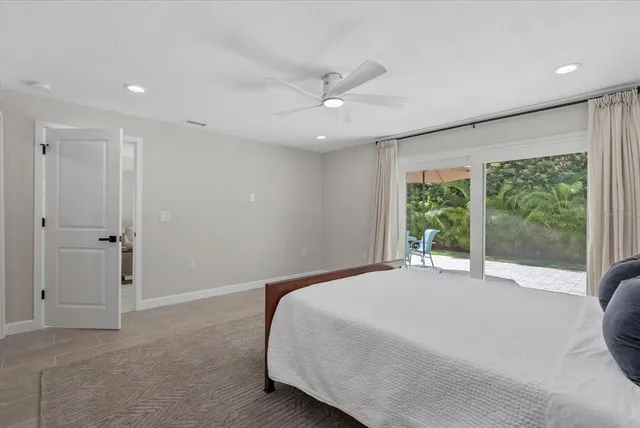 a bedroom with a large bed and a large window