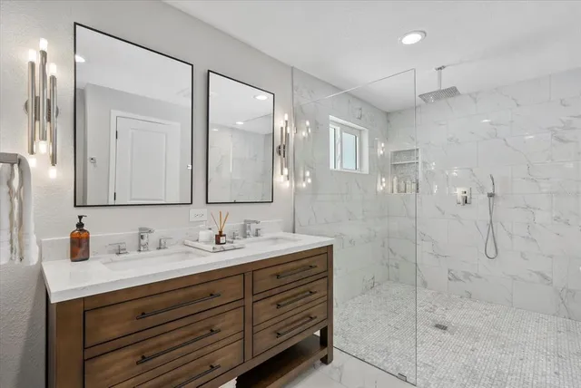 a bathroom with a double vanity sink mirror and shower