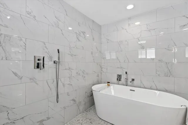 a white bath tub sitting in a bathroom