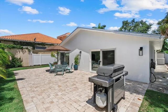a backyard of a house with table and chairs