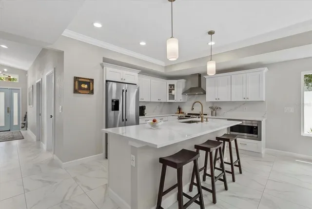 a kitchen with stainless steel appliances a sink stove and refrigerator